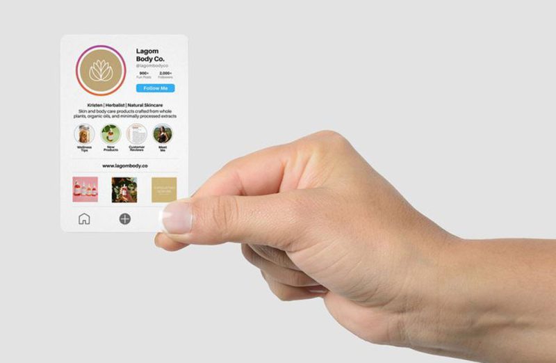 Graphic designer adding social media icons to a business card