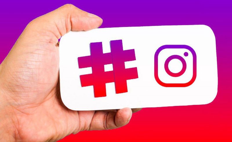 A social media manager using Instagram Insights on a phone to track the performance of a campaign hashtag.